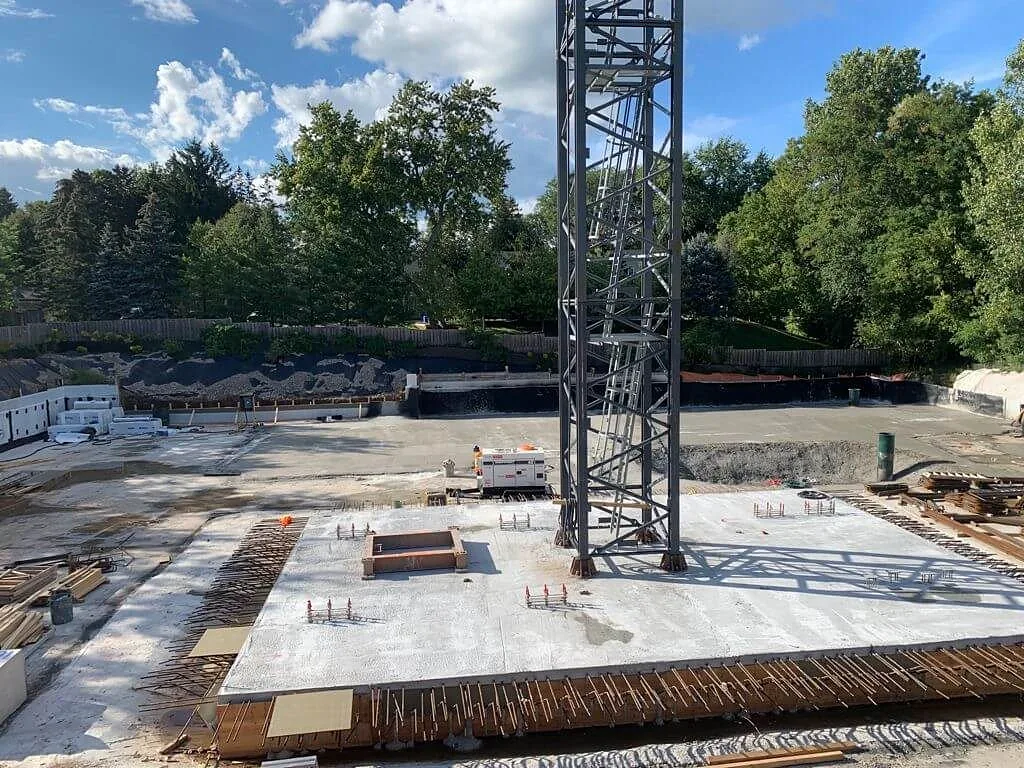 Commercial concrete slab and tower crane on an active construction site
