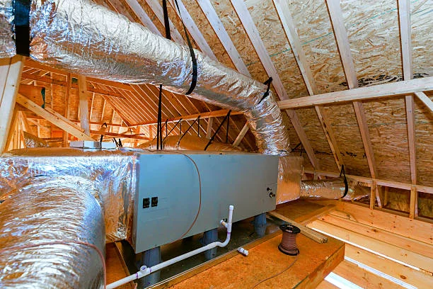 New air handler and insulated ductwork installed in a home attic